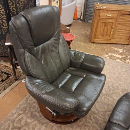 Brown leather recliner chair in a room with furniture and decor.