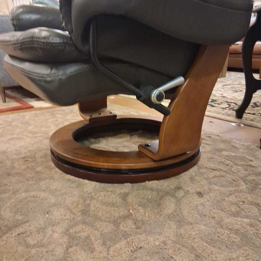 Gray recliner chair with wooden base on a carpeted floor