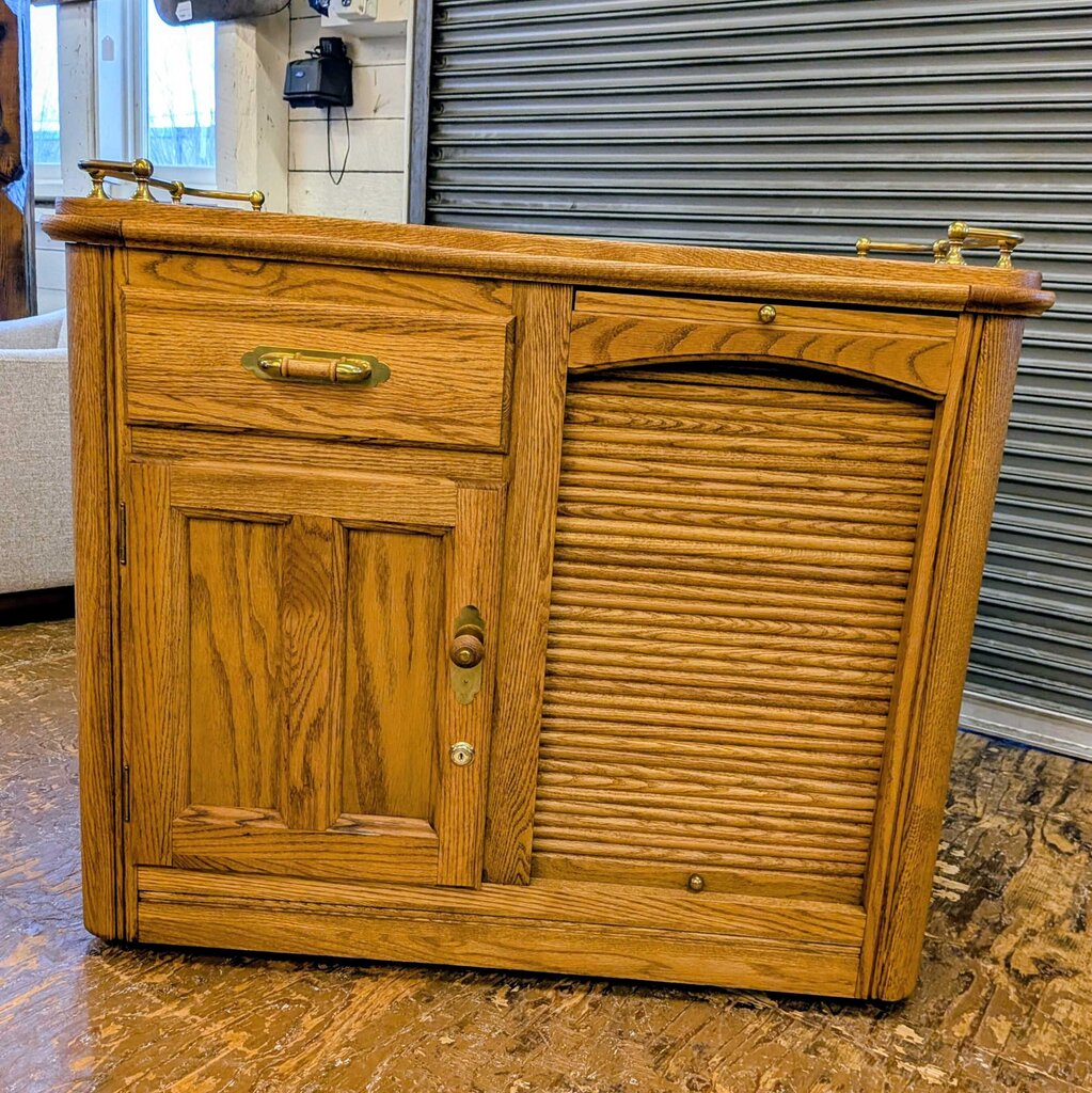 Wooden sideboard with two doors and a drawer in an indoor setting