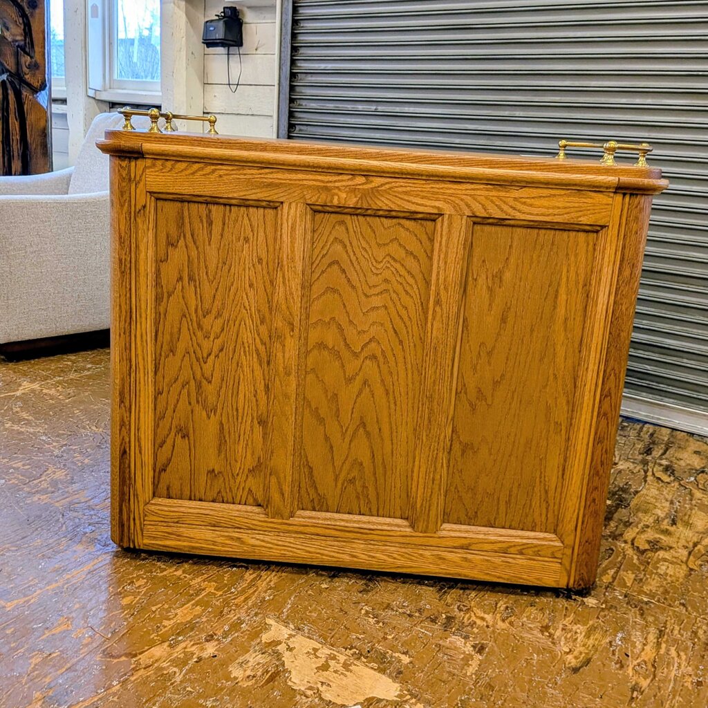 Wooden reception desk in a room with a window and metal shutter.