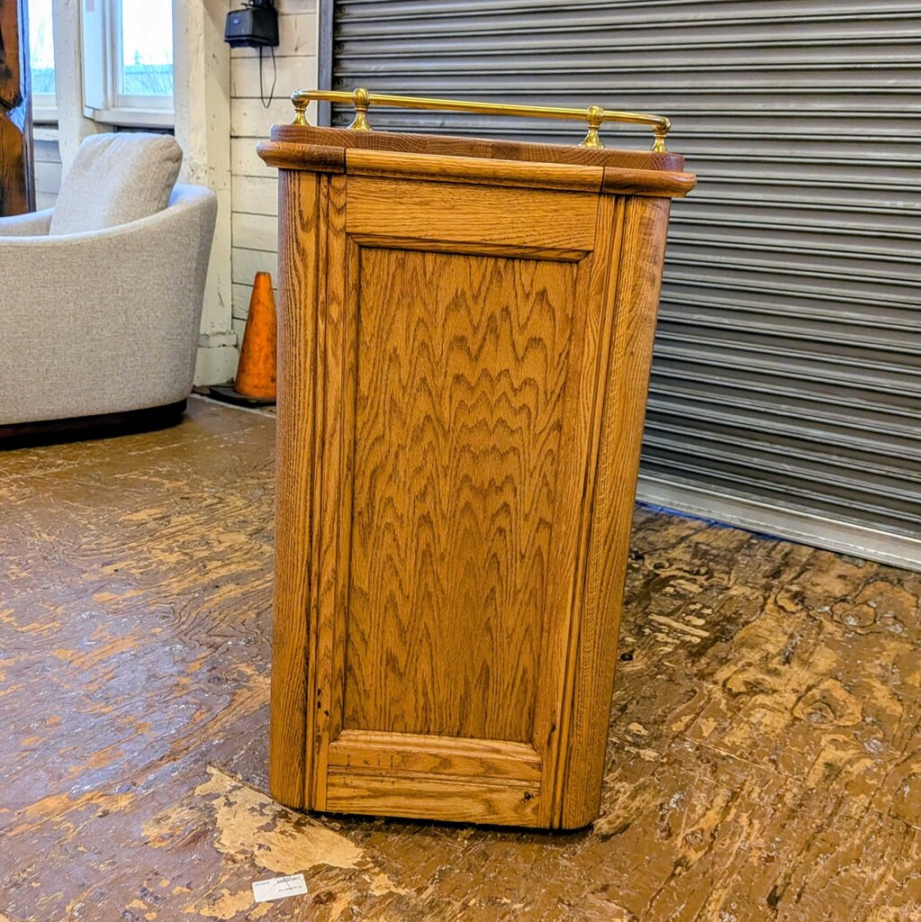 Wooden podium with gold accents on a patterned floor