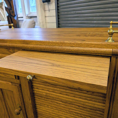 Wooden cabinet with brass handles in a room setting