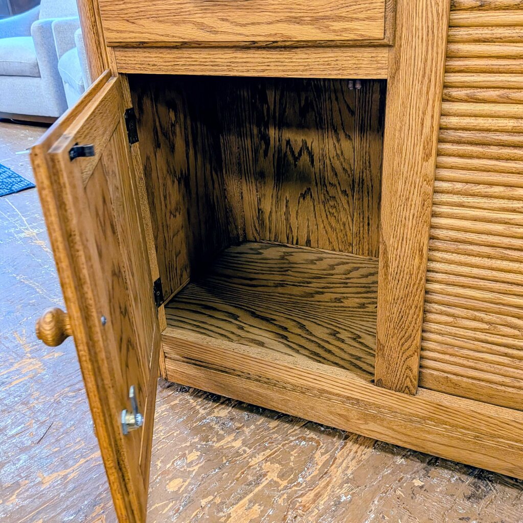 Wooden cabinet with open door on a wooden floor