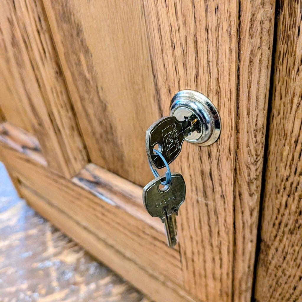 Close-up of a wooden door with a key inserted into a lock