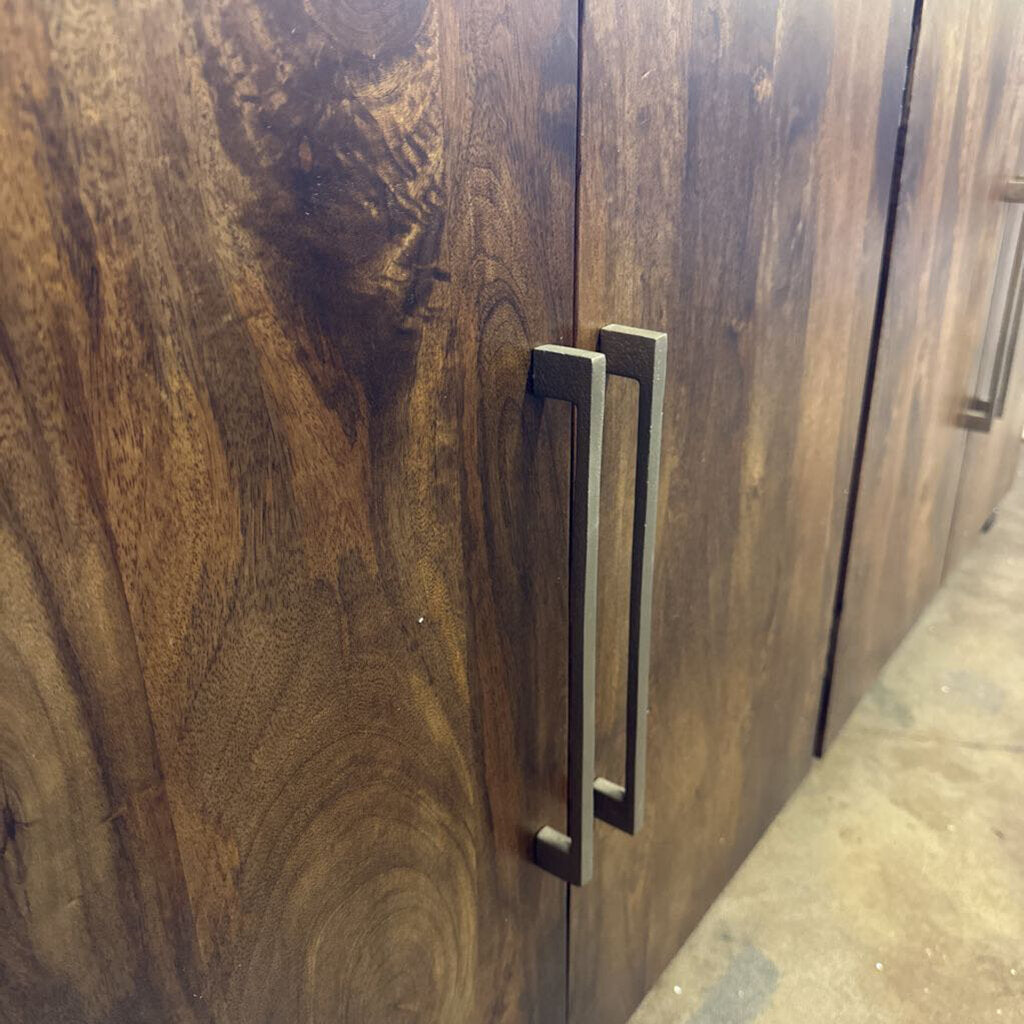 Wooden cabinet with metal handle in a kitchen setting