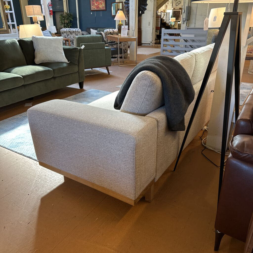 Gray armchair with a blanket in a showroom setting