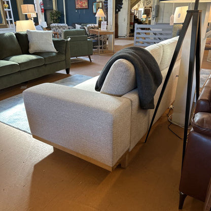 Gray armchair with a blanket in a showroom setting