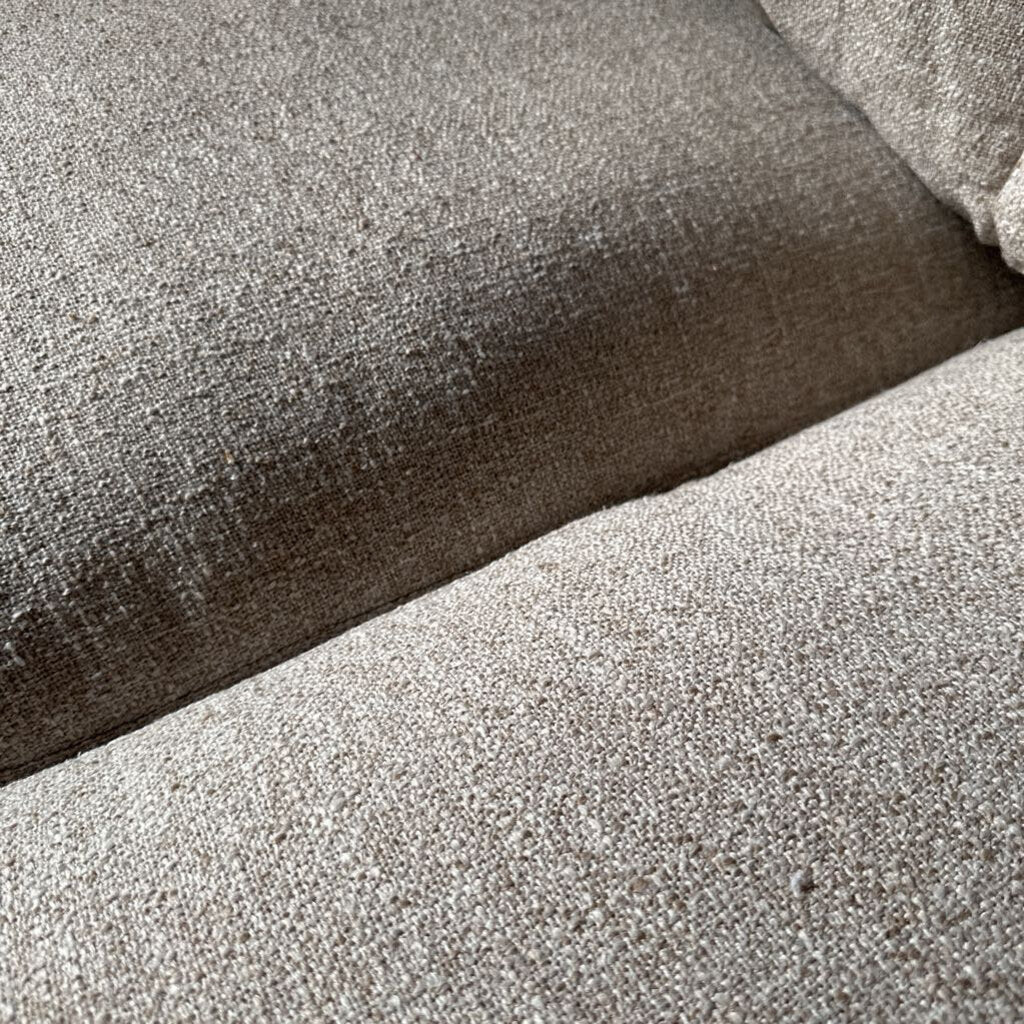 Close-up of textured fabric with a gradient from brown to gray.