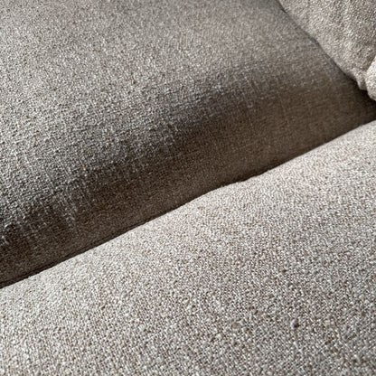 Close-up of textured fabric with a gradient from brown to gray.