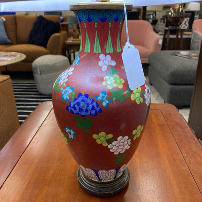 Decorative vase with floral patterns on a wooden table in a furniture store setting