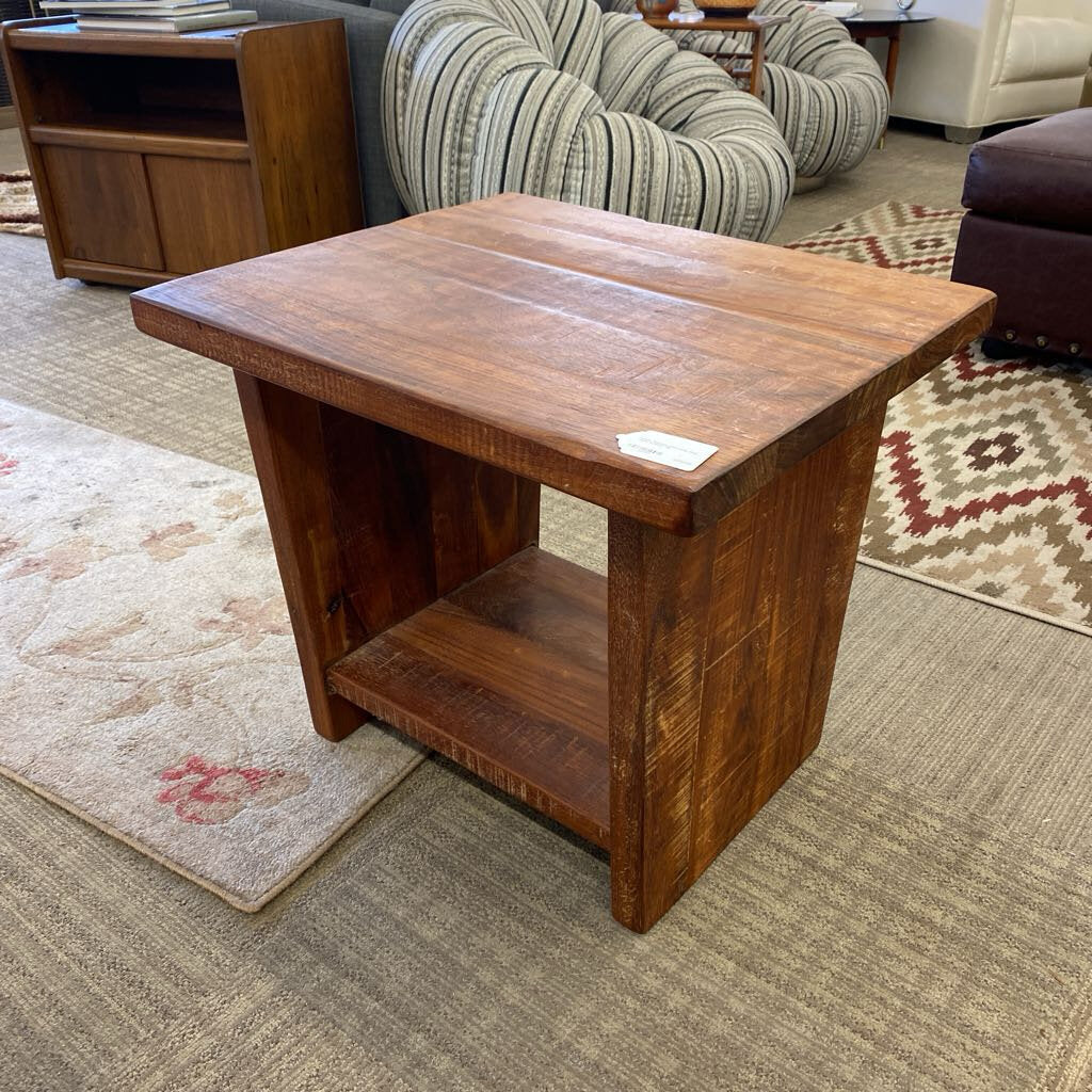 Wooden side table in a room with furniture and rugs