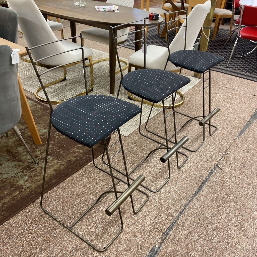 Set of bar stools with blue seats in a casual dining setting