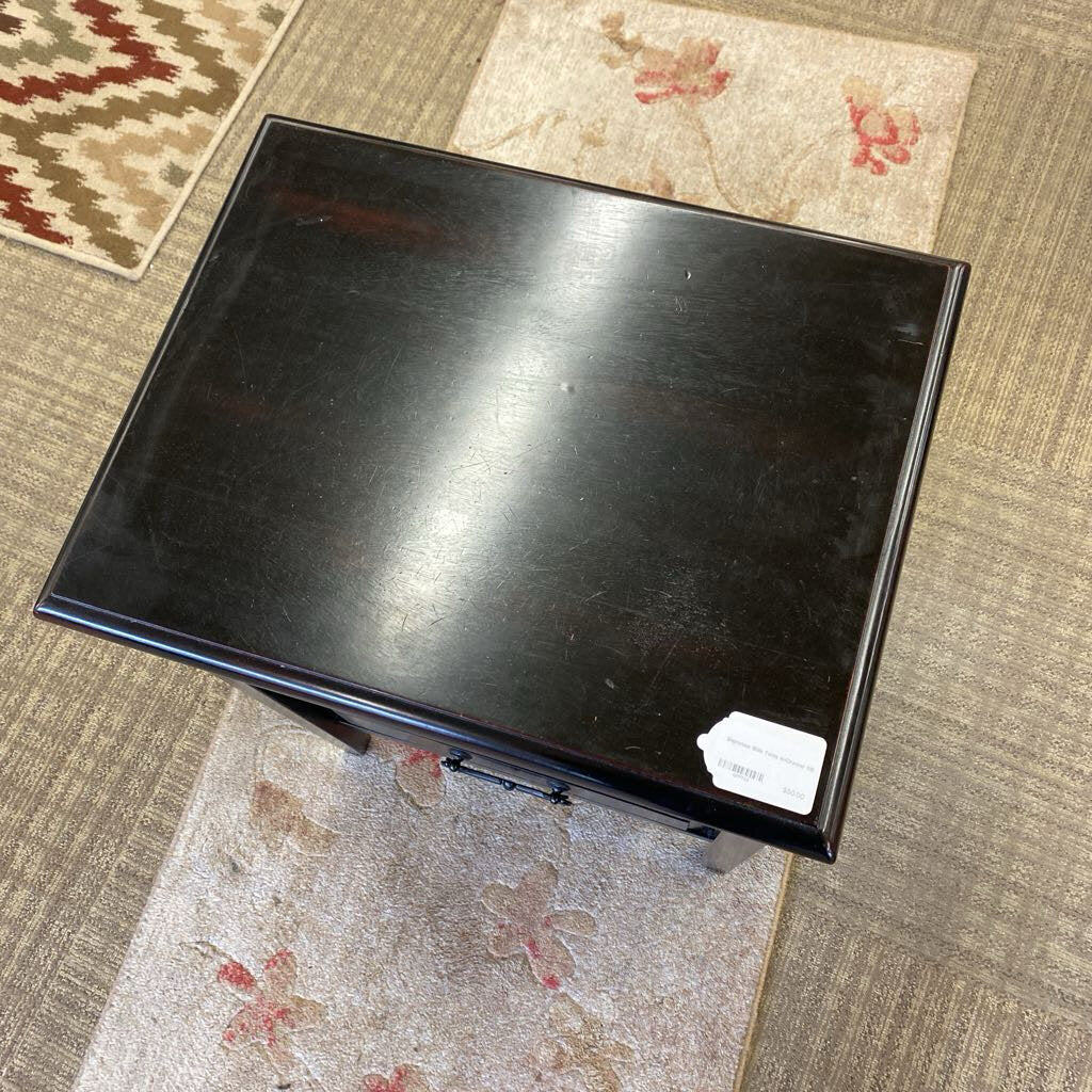 Black metal box on a textured carpet