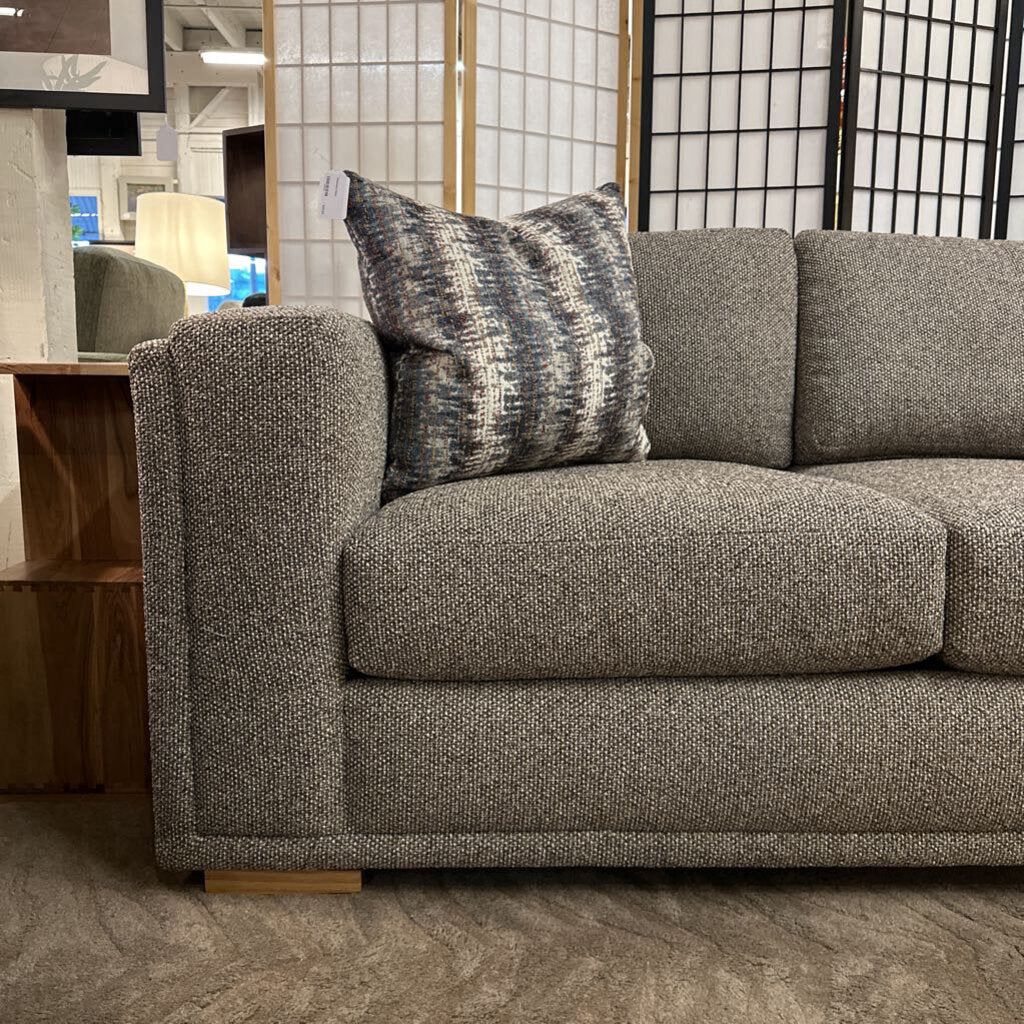 Gray sofa with patterned cushions in a room setting