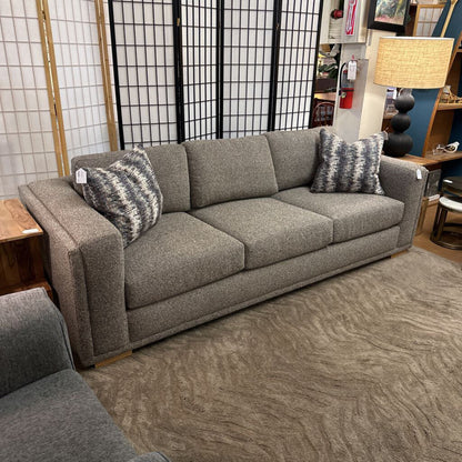 Gray sofa with patterned cushions in a room setting