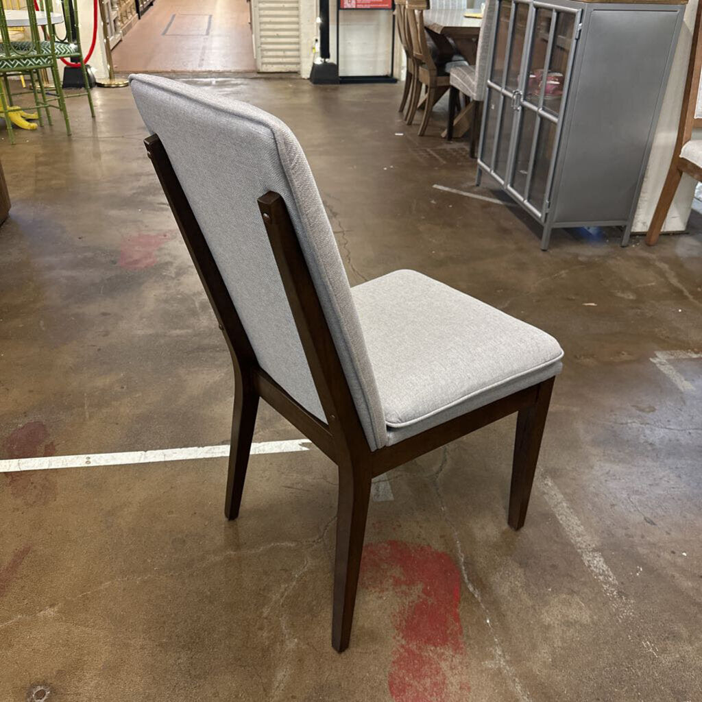 Chair with gray cushion on a concrete floor in an industrial setting