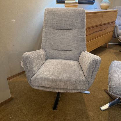 Gray armchair in a room with a wooden dresser.