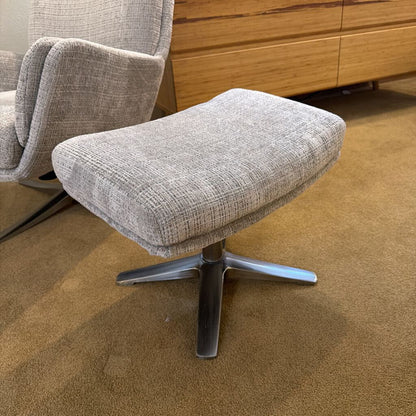 Gray upholstered ottoman with a chair in a room setting.
