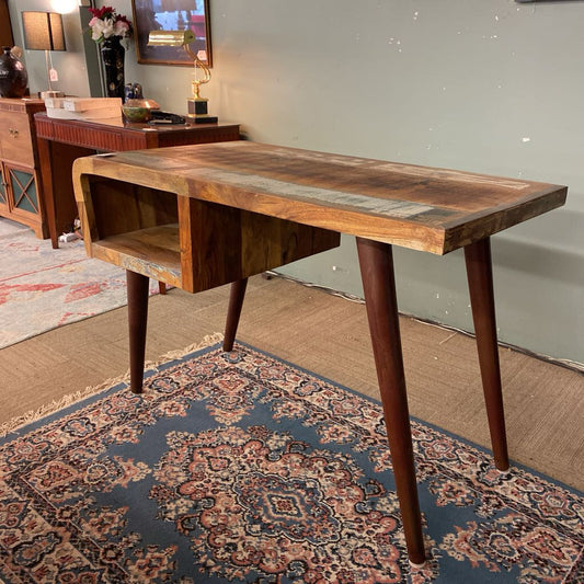 Wooden desk in a room with a patterned rug