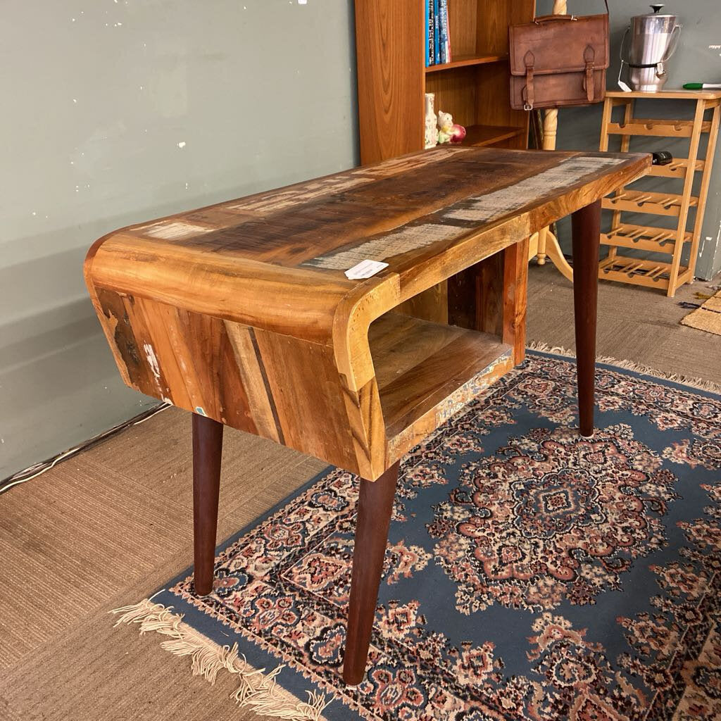 Wooden desk in a room with a patterned rug