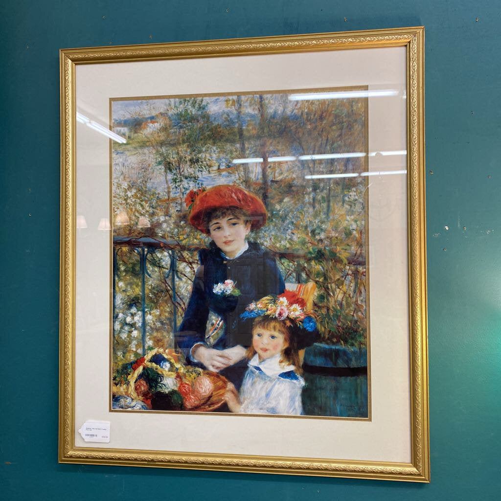 Framed artwork of two women on a balcony with a gold frame.