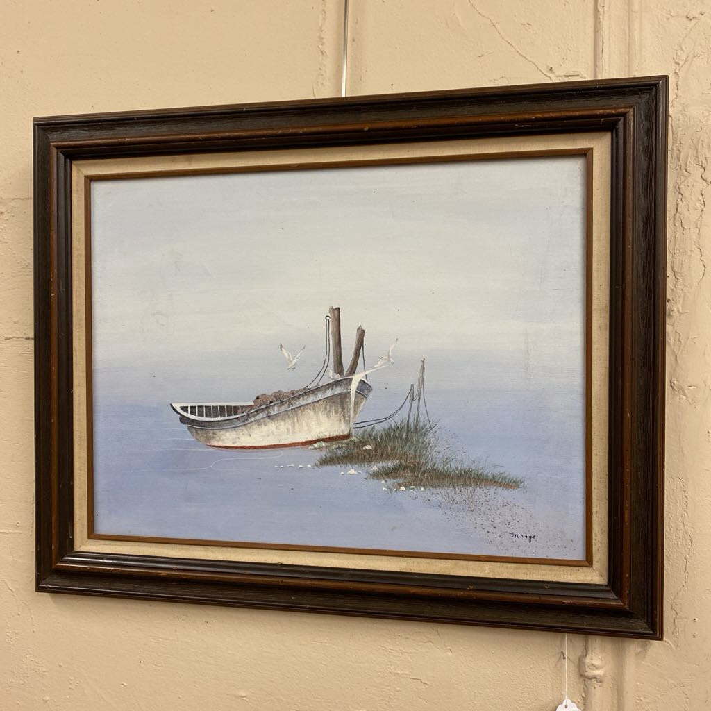 Framed painting of a boat on water with a wooden frame.