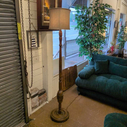 Floor lamp with chain in a room with a couch and plants