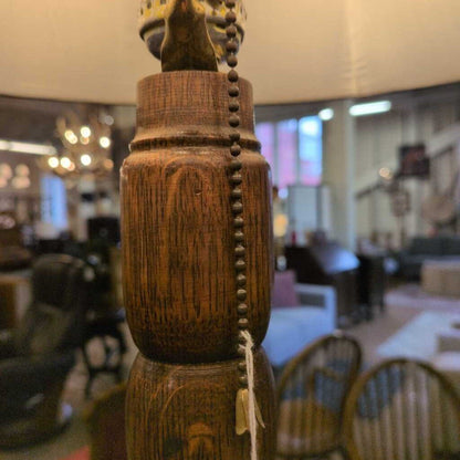 Close-up of a wooden lamp with pull chain in an indoor setting