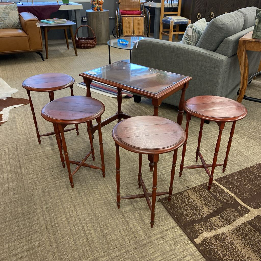 Set of wooden stools and tables on a carpeted floor