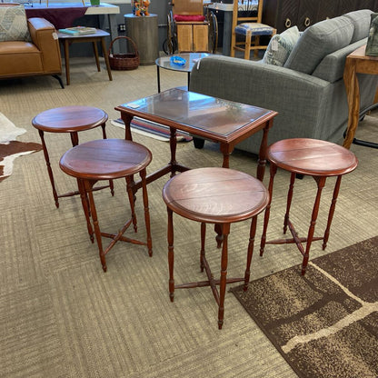 Set of wooden stools and tables on a carpeted floor