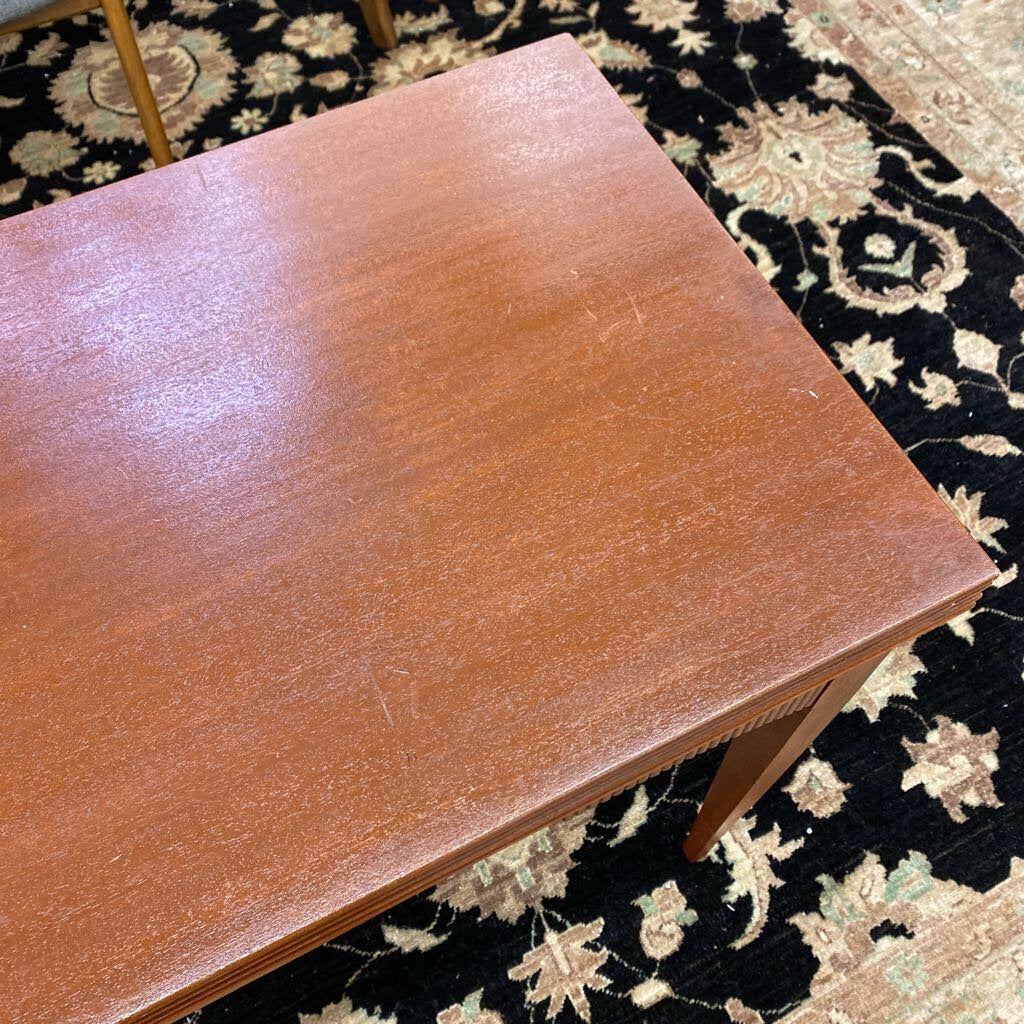 Brown leather-bound book on a patterned rug
