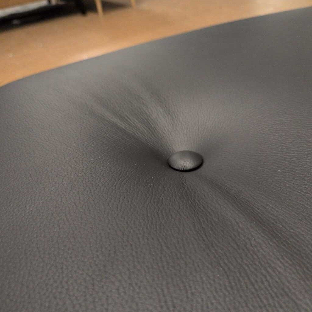 Close-up of a textured gray surface with a small hole.