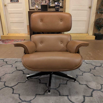 Brown leather armchair with ottoman on a patterned rug