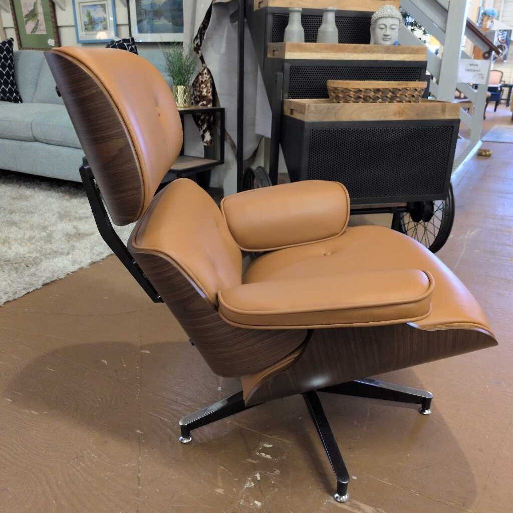 Brown leather lounge chair with ottoman on a marble floor