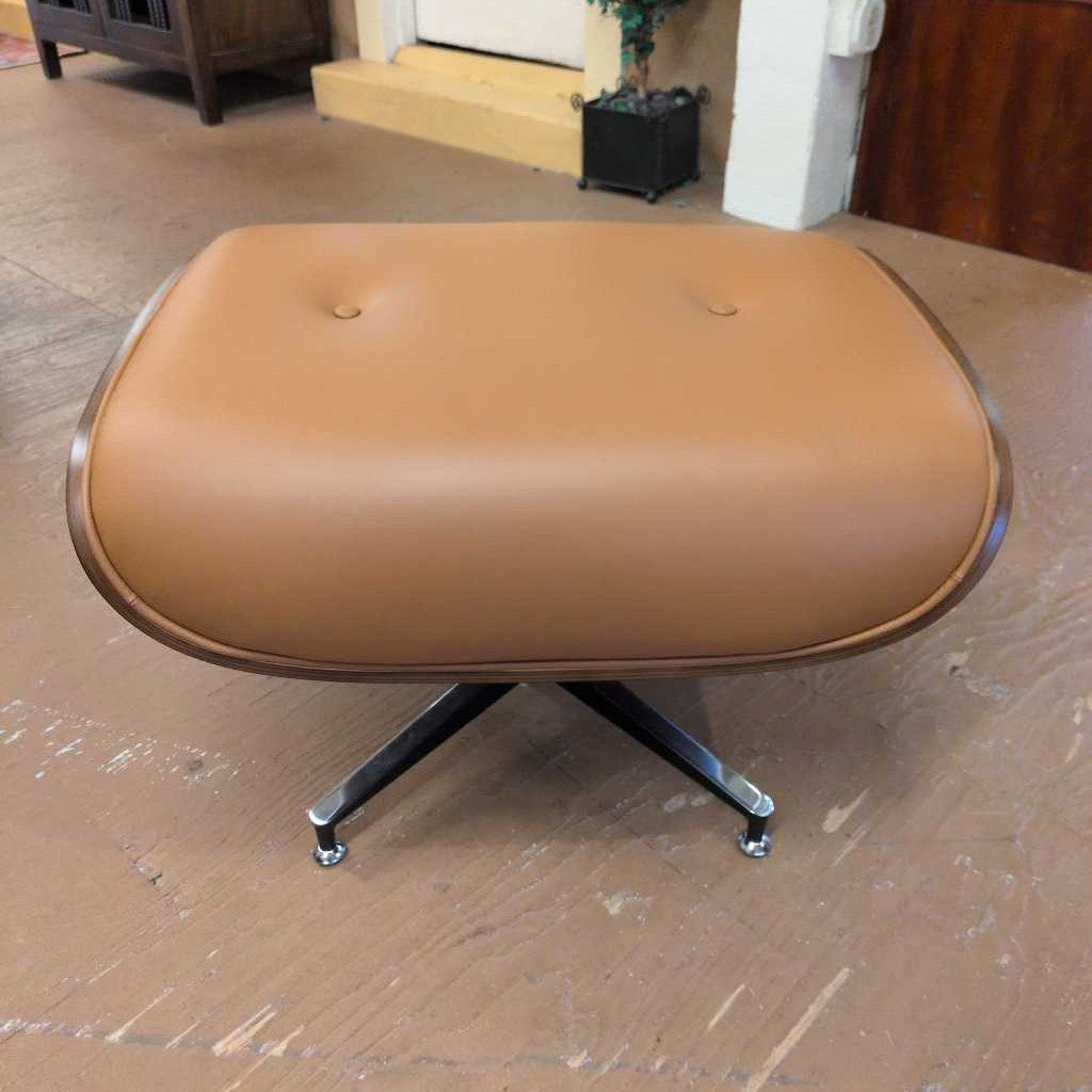 Brown ottoman with wheels on a wooden floor