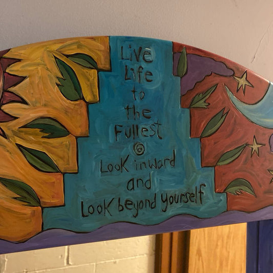 Decorative wall piece with motivational quote and artistic design