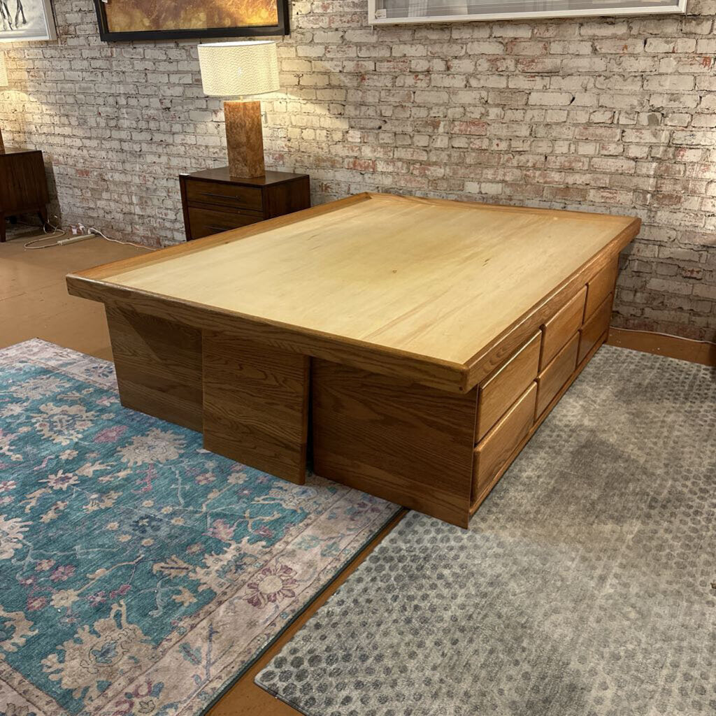 Wooden desk in a room with a brick wall and rug