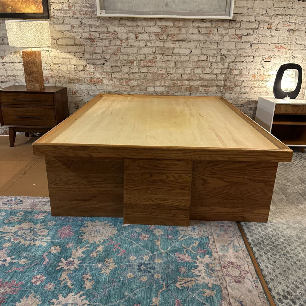 Wooden coffee table in a room with a brick wall and lamps.