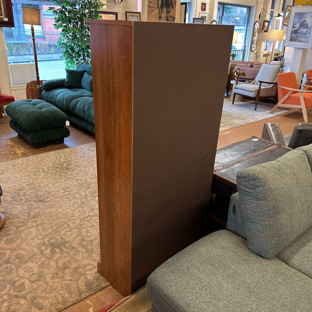 Wooden room divider in a living room setting with furniture and decor.