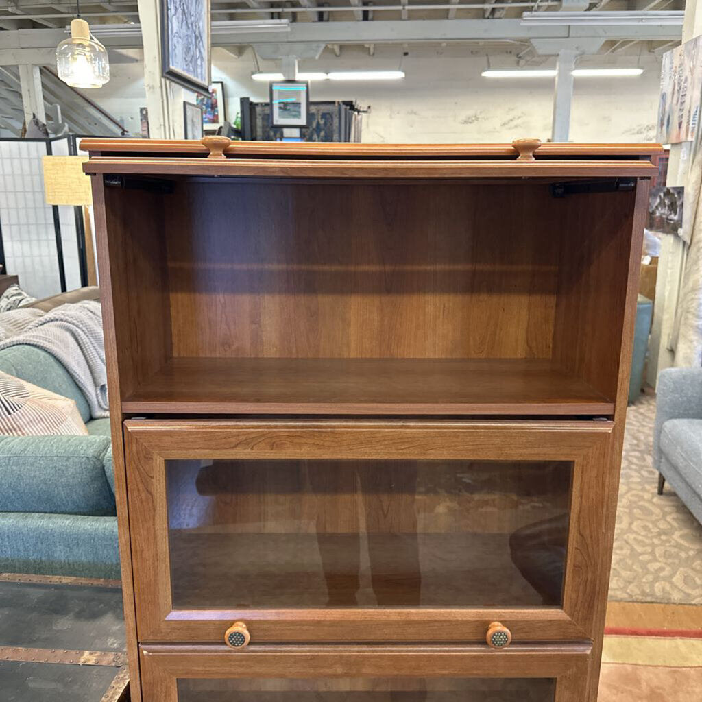 Wooden bookshelf with glass door in a store setting