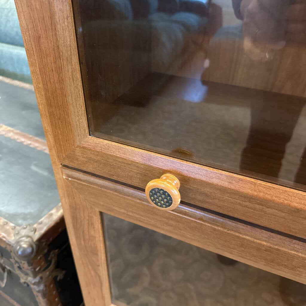 Wooden cabinet with glass door and yellow handle