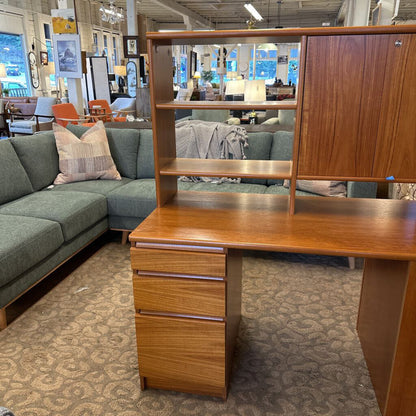 Wooden desk with shelves in a furniture store setting
