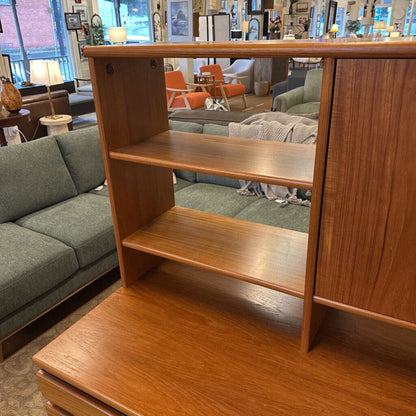 Wooden bookshelf in a room with furniture and decor