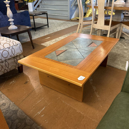 Wooden coffee table with glass top in a living room setting