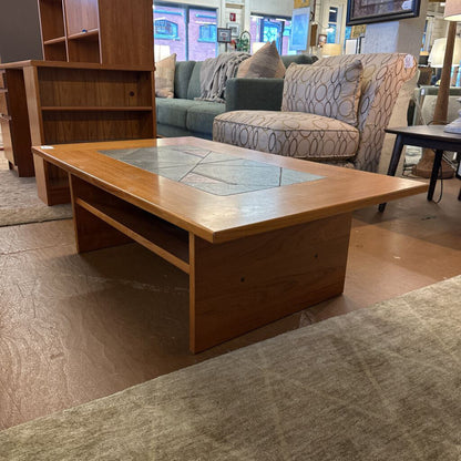 Wooden coffee table with glass top in a furniture store setting