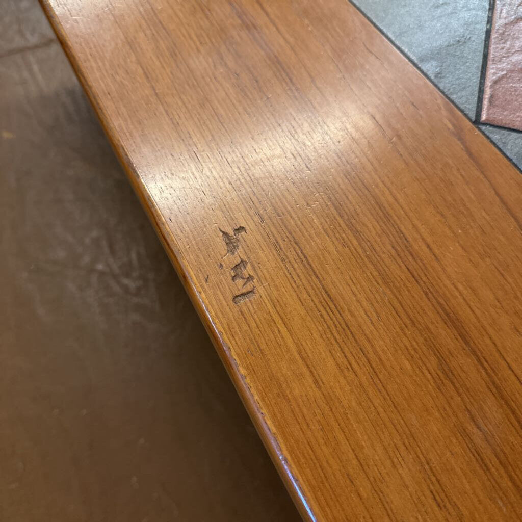 Wooden surface with a visible brand logo.