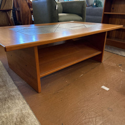 Wooden coffee table with a decorative top in a room setting