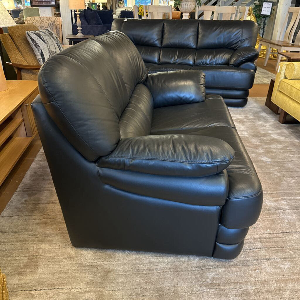 Black leather sofa in a furniture store setting