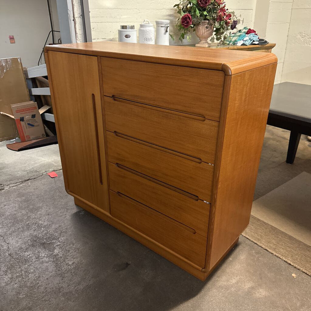 Wooden dresser with four drawers in a room setting