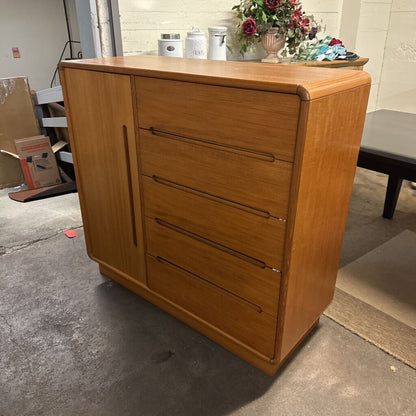 Wooden dresser with four drawers in a room setting